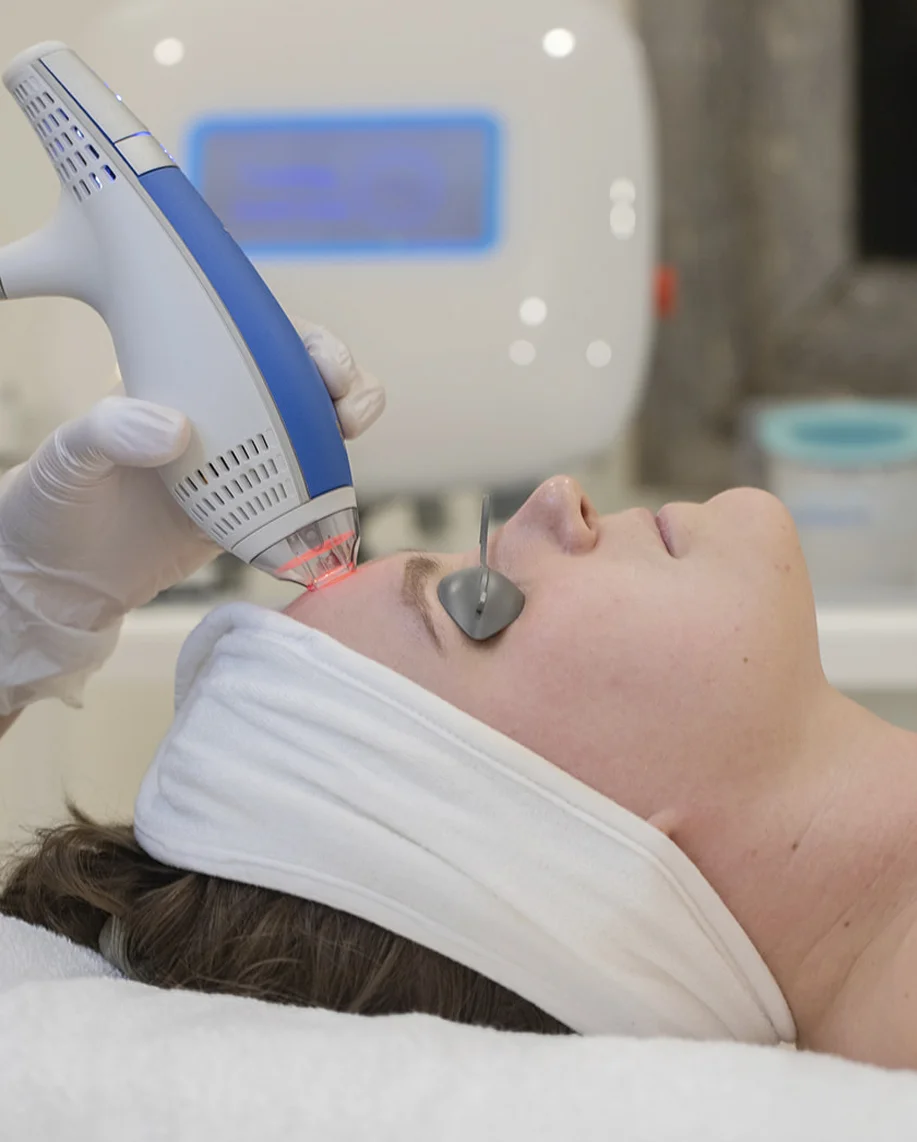 Mini Lift treatment with a handheld device being used on a client\u0027s face